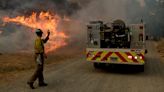 Wildfires: homes burn as flames descend on a Southern California neighborhood