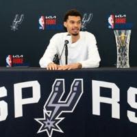 Victor Wembanyama talks to reporters after he was presented with his NBA Rookie of the Year award in San Antonio, Texas