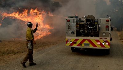 Wildfires: homes burn as flames descend on a Southern California neighborhood