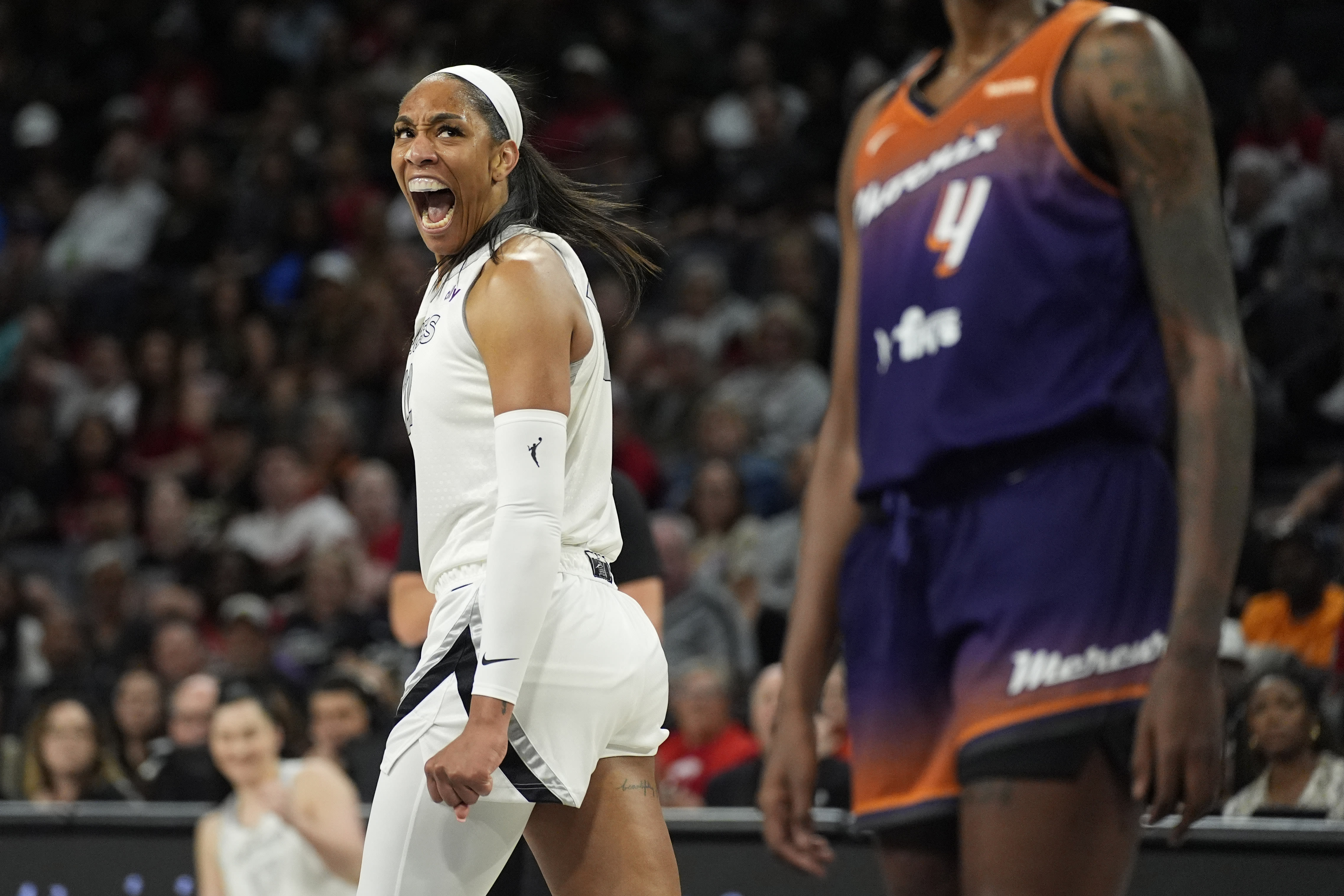 Wilson's double-double leads 2-time champion Aces past Mercury 89-80 in season opener