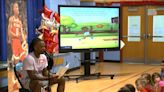 NC State's DJ Horne reads his children's book to Wake County students