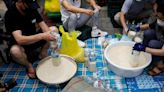 FILE PHOTO: North Korean defector group prepares plastic bottles filled with rice and masks to be sent towards North Korea