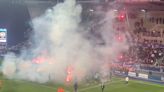 French match abandoned as fans protest with flares and players throw them back