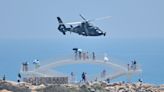 Photos show China starting military drills around Taiwan as seaside tourists look on after Pelosi's visit