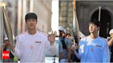 BTS' Jin receives thundering cheers as he carries Paris Olympics torch: I'm very honored | K-pop Movie News - Times of India