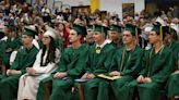 Graduates sit in their chairs