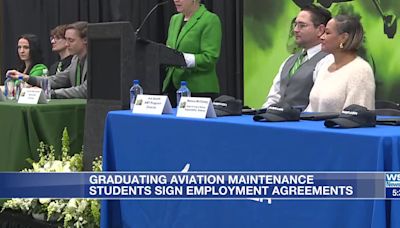 Graduating aviation maintenance technology students sign employment agreements