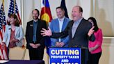 Gov. Polis signs cuts to income, sales and property taxes into law as ballot fight looms