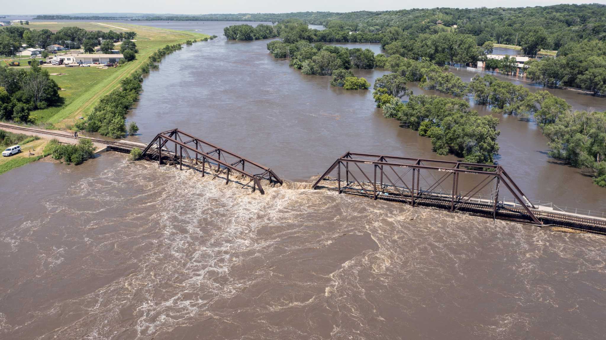 Midwestern flooding collapses a bridge, forces evacuations and kills at least 2