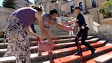 Women's rights activists cover Rome's Spanish Steps in red paint