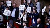 Macron forces plan to raise retirement age through French parliament without vote