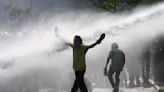 Police in Sri Lanka use tear gas to disperse opposition protest against dire economic conditions