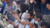 Families leave offerings for children slain at Thai day care