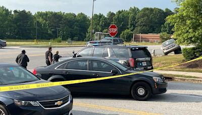 Woman found shot to death after car crashes in DeKalb County