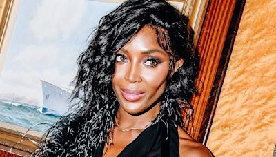 Naomi Campbell goes braless in a daring sheer black dress