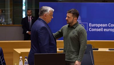 Orbán and Zelenskyy have charged conversation on sidelines of EU summit after shaking hands – video