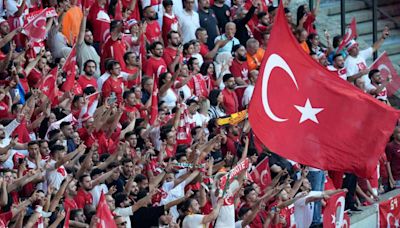 Turkey fans do wolf salute, President Erdogan in Berlin stadium