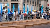 Mock coffins fill a square in Milan in a protest over workplace safety in Italy