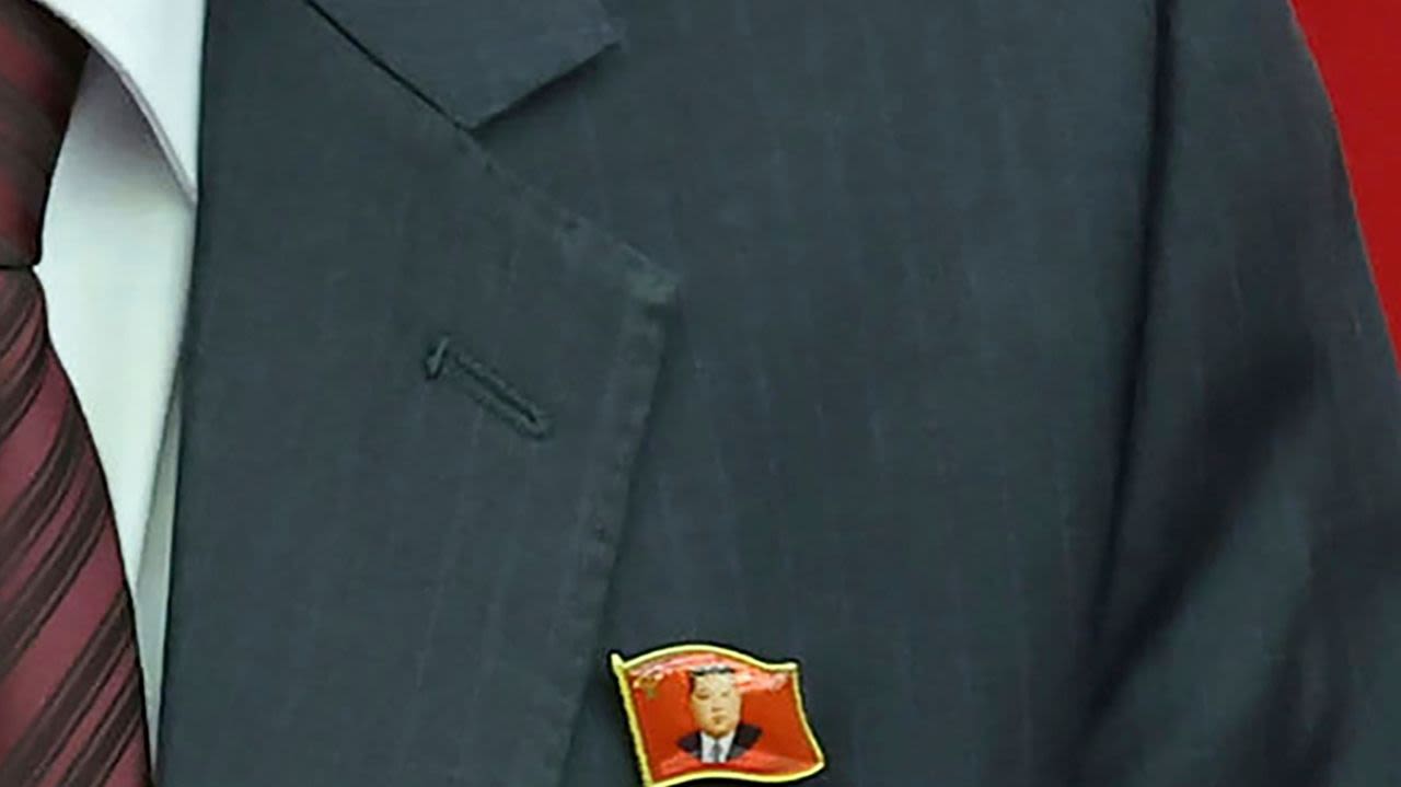 North Koreans are seen wearing Kim Jong Un pins for the first time as his personality cult grows