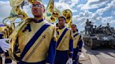 Dodging tanks, storming a beach, the St. Aug Marching 100 makes memories in France