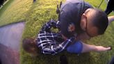 Video shows cops holding a mom down in bed of fire ants as they attacked her face and she pleaded for help