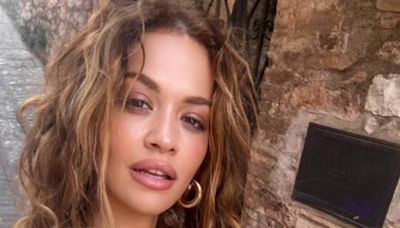 Rita Ora shows she poses in a tiny bikini while on a trip to Italy