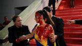 Cannes Red Carpet Protests Include Woman In Ukraine Dress Covered In Fake Blood, Anti-Surrogacy Group In Rare Show Of...