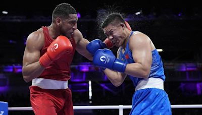 El boxeador Emmanuel Reyes resiste la tormenta del chino Xuezhen y luchará por las medallas