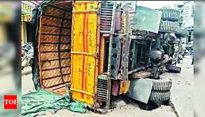 City road caves in as truck falls over | Hyderabad News - Times of India