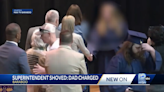 Dad pushes superintendent away from graduating daughter, video shows. He’s charged