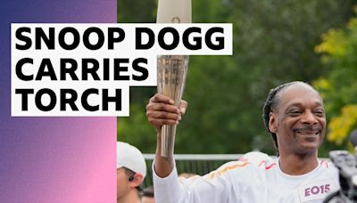 Snoop Dogg carries Olympic torch through Paris before opening ceremony