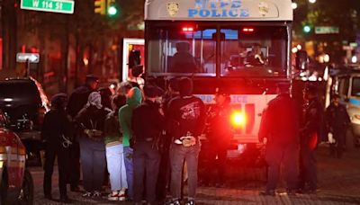 NYC finally cracks down - Columbia rioters taken away in buses as cops reinstall American flag at another campus and Eric Adams slams college's 'despicable' complacency