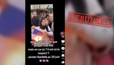 No, this photo doesn’t show a Muslim woman in France burning a French flag