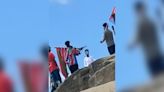 Shocking video shows men with flags and 'gun' at popular spot as cops called
