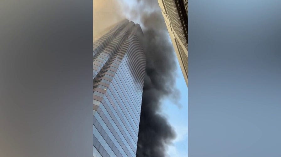 Smoke rises above the historic First Baptist Church in downtown Dallas