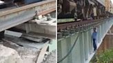 Indian Railways staff walk on edge of bridge, crawl under train to fix air leakage. Watch shocking video