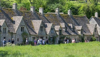 Tourists spotted climbing private walls and jumping fences in Cotswolds village to snap selfies