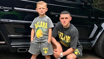 Phil Foden poses with son Ronnie in matching lemon-themed outfits