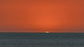Why is there sometimes a green flash at sunset and sunrise?