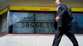 Stock market today: Asian shares edge lower after Wall Street sets more records