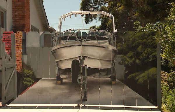 Man gets realistic picture of his boat painted on a fence intended to hide it