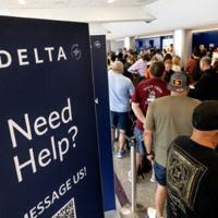 Travelers wait in line at the airport in Los Angeles, California on July 19, 2024 following a global IT crash that hobbled airlines, banks, broadcasters and other businesses