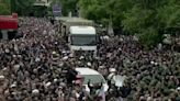 Mourners surround truck carrying remains of Iran president killed in helicopter crash