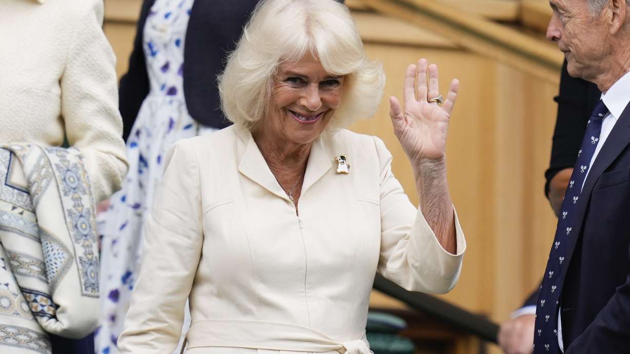 Queen Camilla visits Wimbledon and joins fans in doing 'the wave'