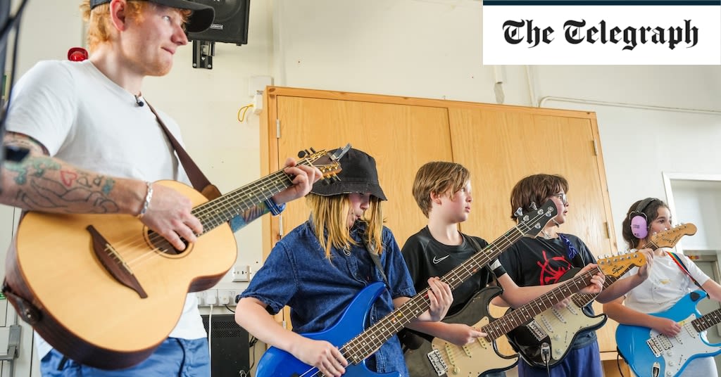 Ed Sheeran surprises primary school children with classroom gig