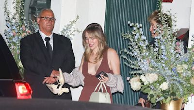 Suki Waterhouse carries heels in hands as she leaves a party barefoot