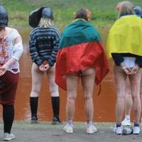 Women stand with marks of dripping blood on their naked legs during a protest near the Russian embassy in Vilnius, Lithuania in April 2022, against the alleged rapes of Ukrainian women by Russian soldiers