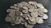 Detectorist friends find hoard of 161 Roman coins beneath their campsite