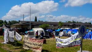 Hundreds of asylum-seekers are camped out near Seattle. There's a vacant motel next door