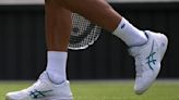 Novak Djokovic plays at Wimbledon with the number '23' printed on his white tennis shoes